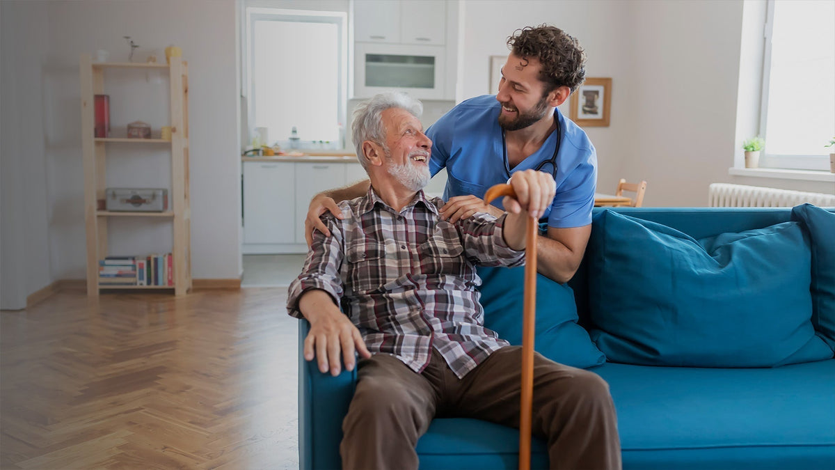 Older man using a simple foot care routine with family support
