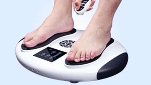 Hand using the remote control for the WY-360 EMS foot stimulator