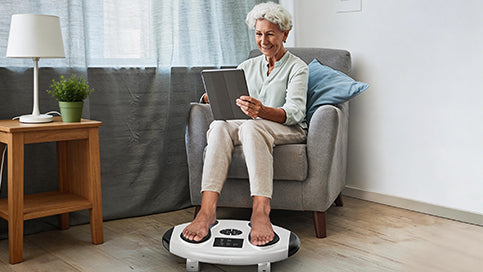 Woman relaxing at home while using the WY-365 EMS foot stimulator